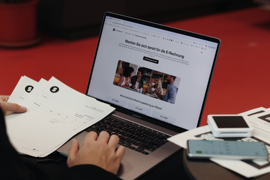 Person fact-checking news on laptop with documents